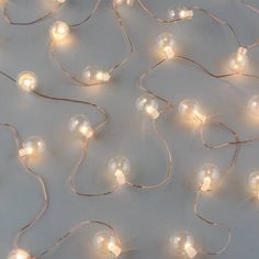 a bunch of white lights that are on a wall with some wires attached to it