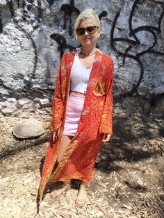 One of a kind sustainable jacket made with vintage kantha cotton.  One size only fits upto 2XL Bohemian Long Sleeve Patchwork Kimono, Patchwork Wrap Kimono, Long Patchwork Kimono For Festivals, Long Patchwork Festival Kimono, Red Bohemian Outerwear With Kimono Sleeves, Bohemian Red Outerwear With Kimono Sleeves, Long Vintage Kimono For Festivals, Bohemian Long Kimono For Fall, Bohemian Patchwork Beach Outerwear