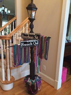 a street sign with beads hanging from it's pole in front of a staircase