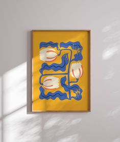 a yellow and blue painting hanging on the wall next to a white wall with sunlight coming through it