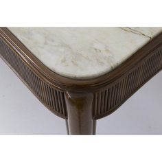 a marble topped table with wooden legs