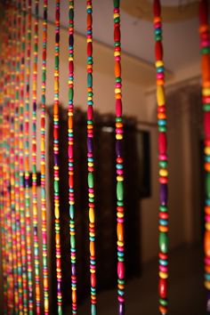 multicolored beads hanging from the ceiling in a room