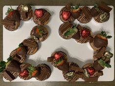 chocolate covered strawberries are arranged in the shape of a wreath on a white platter