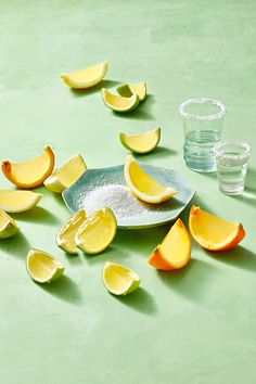 sliced lemons on a plate with salt and water in the backgroung