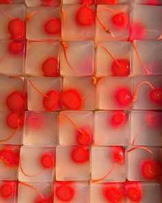 several cubes with cherries on them in red and white colors are arranged together