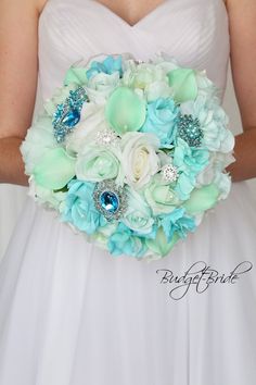 a bridal bouquet with blue and white flowers on the bride's wedding day