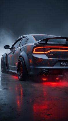 the rear end of a gray dodge charger with red lights on it's taillights