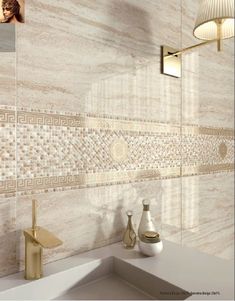 a bathroom with a sink, mirror and tiled backsplash in beige tones on the wall