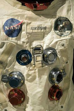 an astronaut's space suit with buttons and badges on the outer part of it