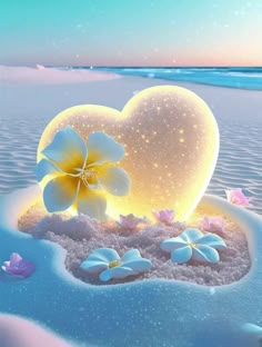 a heart shaped object sitting on top of a sandy beach next to the ocean with flowers