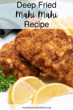 deep fried mahi mahi recipe on a plate with lemon wedges and parsley