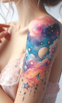 a woman's arm with stars, moon and clouds on the side of her body