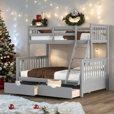 a white bunk bed sitting next to a christmas tree