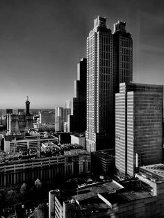 black and white photograph of city skyline with skyscrapers in the foreground, looking east