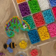 there are many different beads in the plastic container and one is made out of legos