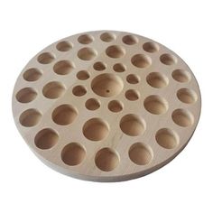 a wooden tray with holes in it on a white background and the lid is made out of plywood