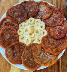 some pancakes and bananas on a white plate