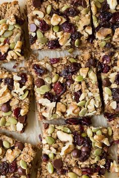 granola bars cut into squares with nuts and dried cranberries on the top