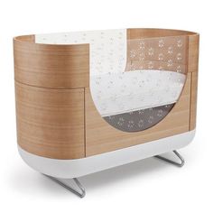 the baby crib is made out of wood and white plastic with stars on it