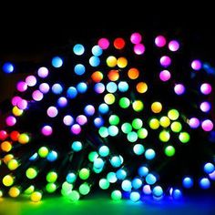 a bunch of colorful lights that are on the ground in front of a black background