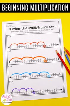 a number line worksheet with two pencils on top of it and an image of