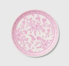 a pink and white plate with flowers on it