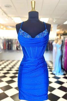 Introducing Cecily, a homecoming dress designed for the modern queen. Made from a shimmering jersey fabric, this sheath-style dress beautifully hugs your silhouette, revealing a fusion of confidence and grace. The dress boasts delicate spaghetti straps leading to a sultry V-neckline. The intricately designed drapes over the bust are complemented by the gentle pleats on the skirt. But the true star is the beading on the front neckline - a touch of sparkle to make sure you shine. Completed with a Tight Homecoming Dress, Hoco Inspo, Bodycon Dress Homecoming, Short Fitted Dress, Hoco Dress, Blue Corset, Red Corset, Dress Homecoming, Senior Prom