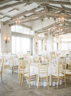 tables and chairs are set up with white tablecloths for an elegant wedding reception