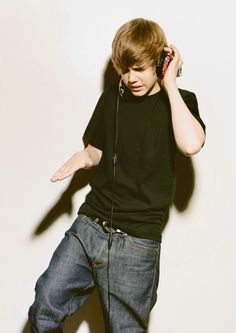 a young man is listening to music with headphones