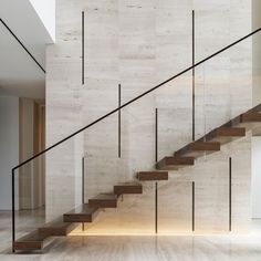 the stairs are made of wood and glass in this modern house, which has been designed to look like stone