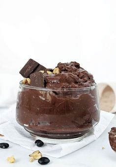 a glass bowl filled with chocolate and nuts