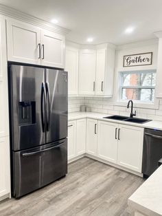 a black refrigerator freezer sitting inside of a kitchen