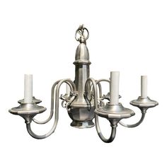 a silver chandelier with five candles on it