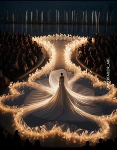 a model walks down the runway in a white dress with long flowing fabric on it