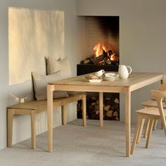 a dining room table with chairs and a fire place