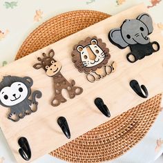 the wooden pegs are decorated with different animal magnets on them, along with black handles