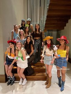 a group of young women standing next to each other in front of a stair case