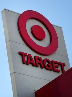 a target sign on the side of a building with blue sky in the back ground