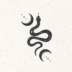 a black snake with crescents and stars on it's tail, in the middle of