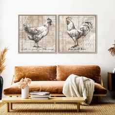 two pictures of roosters are hanging on the wall above a brown couch in a living room