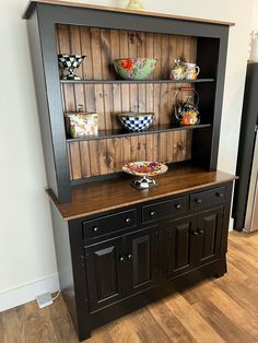 a wooden hutch sitting on top of a hard wood floor