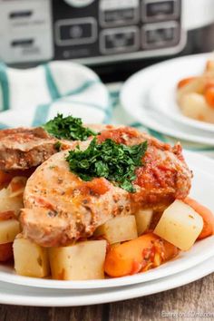 two white plates filled with meat and vegetables next to an instant pot pressure cooker