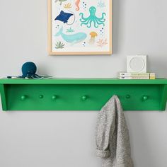 Add a pop of color and brilliant organization to your little one's wall with this vibrant shelf. Crafted of solid wood, it offers five pegs for hanging coats and backpacks, plus a shelf for grab-and-go items. KEY PRODUCT POINTS Handcrafted from solid poplar wood and finished with acrylic latex paint in a variety of vibrant colors (each sold separately). Pegs are made from 100% birch wood. BPA-, Phthalate- and Lead-free. Mounting hardware is included. Domestic. Shelf With Pegs, Kids Bathroom Organization, Lilac Nursery, Blue Shelves, Bathroom Organizers, Shelf Hooks, Kids Shelves, Clever Organizer, Bathroom Necessities