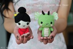 two small crocheted dolls are held in their hands