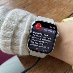 an apple watch with the heart rate displayed on it's screen, sitting on a person's arm