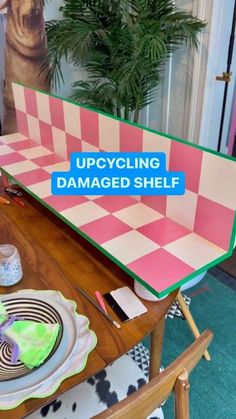 an upcycling damaged shelf is sitting on a table with plates and cups