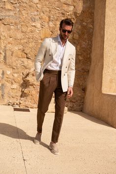 Our iconic Soragna fit features a high-rise and a semi-slim fit, a large extended 2-button belt, side adjusters and single pleats. It is the perfect pair of trousers for any occasion and can easily be dressed up with a shirt, tie and jacket or worn casually with a simple shirt or knit. Composition: 98% cotton, 2% elastane, 430g, woven in ItalyColour: BrownHigh-rise with a semi-slim fit Large extended tab fastening beltSingle pleatsSide adjustersAfter-dinner splitCoin pocketMade in ItalyAll our t Mens Wedding Suits 2023, Suit Combinations Men, Beige Suits For Men, Office Old Money, Old Money Fashion, Money Fashion, Cream Trousers