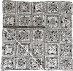 a gray and white crocheted blanket with squares on the bottom, one square has been