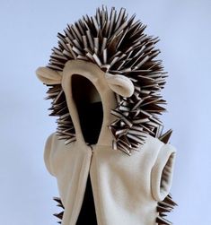 a sculpture of a hedgehog wearing a white coat with spikes on it's back