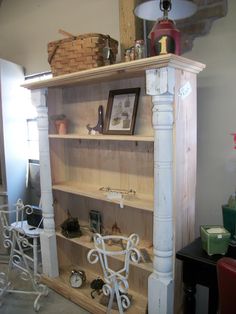 an old white bookcase with pictures on it